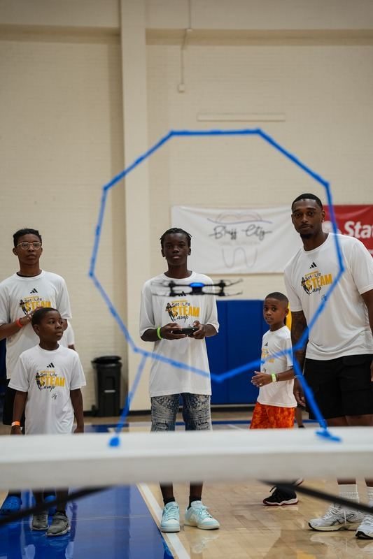 Kids flying drones at a hands-on learning day